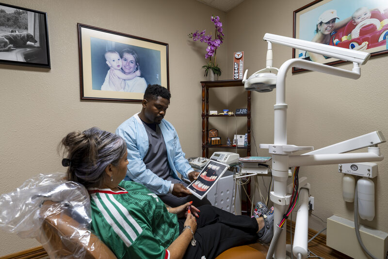 Dentist reviewing dental implant treatment options chairside with a patient in Fort Worth